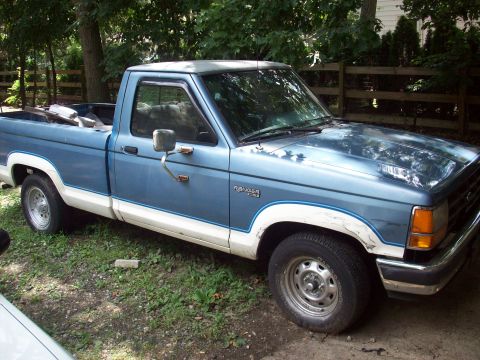 1990 Nissan Sentra - This blue and white Ford Ranger pickup truck is shown from the front three-quarter angle.