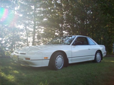 1990 Nissan Sentra - A white coupe is parked on a grassy lawn with trees in the background.