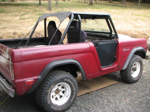 1968 Ford Bronco - A red 1968 Ford Bronco is shown with its doors removed and a soft top installed.
