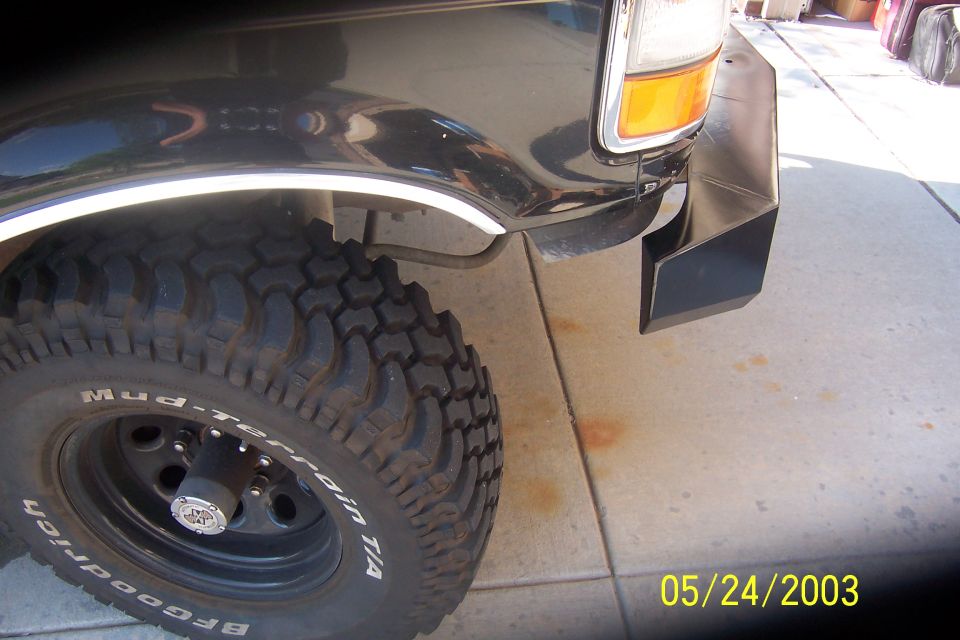 BFGoodrich Mud-Terrain T/A tire on black steel wheel, front fender of black Bronco, dated 05/24/2003