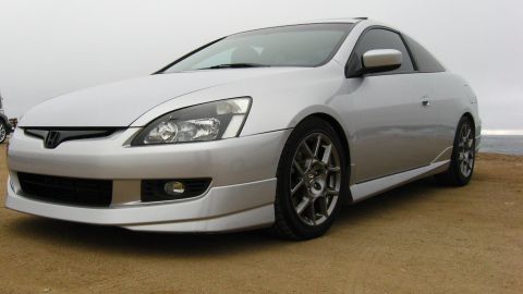 2003 Ford Taurus - Low front three-quarter view of a silver Honda Accord coupe with a body-color front lip, side skirts, tinted windows and dark gray multi-sp…