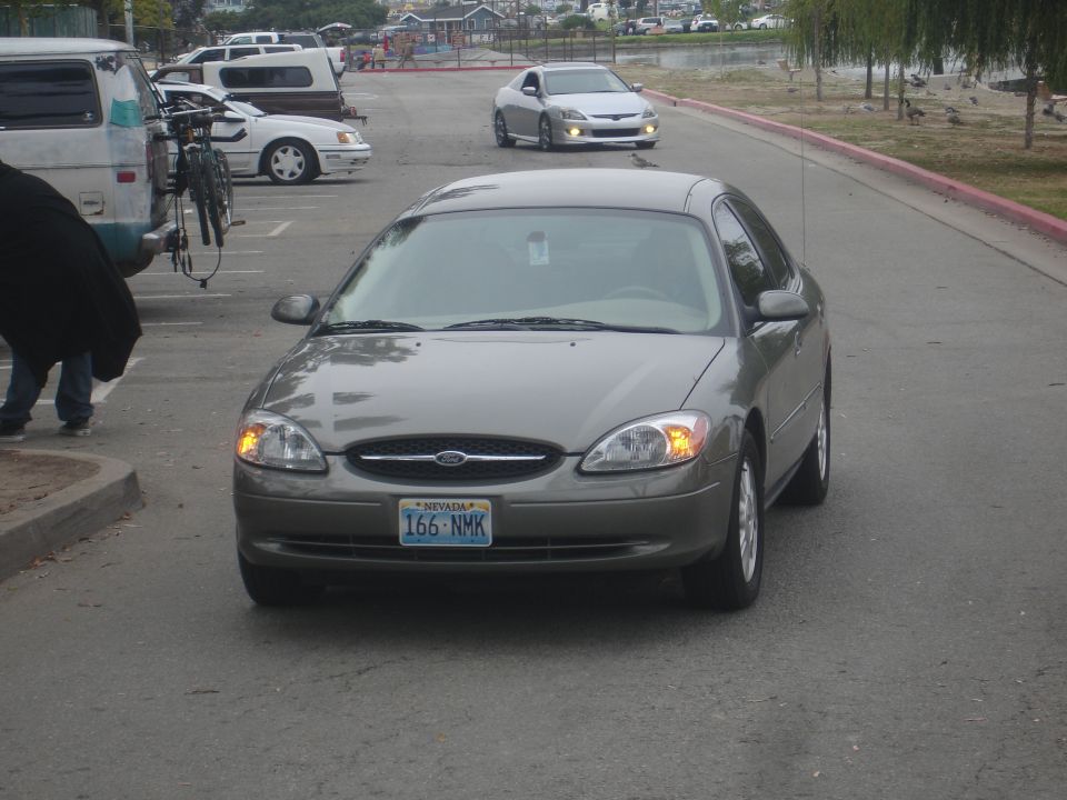 Silver Ford Taurus with Nevada license plate 166-NMK parked.