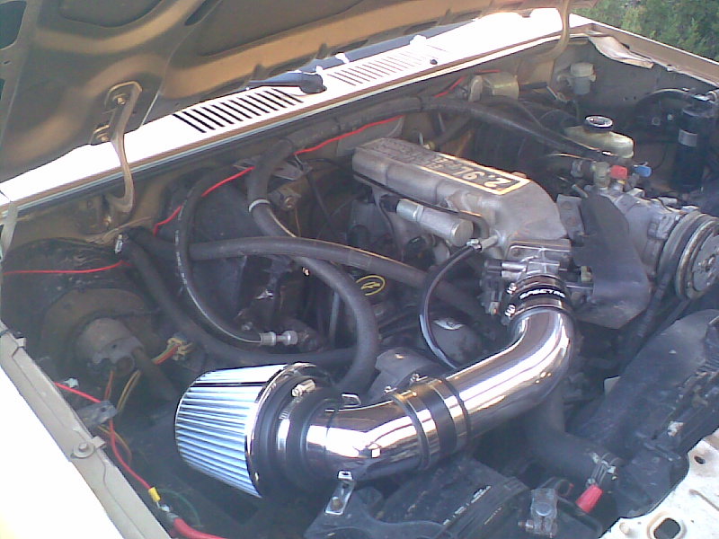 Ford Bronco II engine bay with chrome aftermarket air intake.
