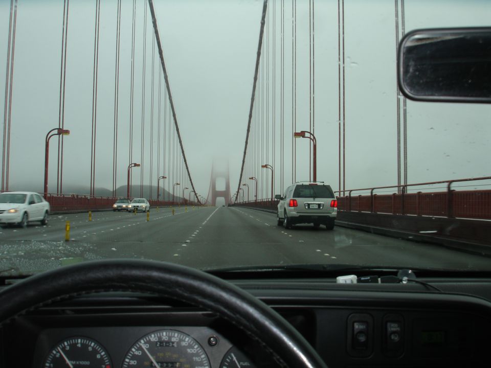 Driving on the Golden Gate Bridge in fog, view from inside the car.