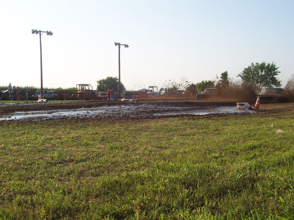 Dodge pickup truck splashing mud during a mud bog event.