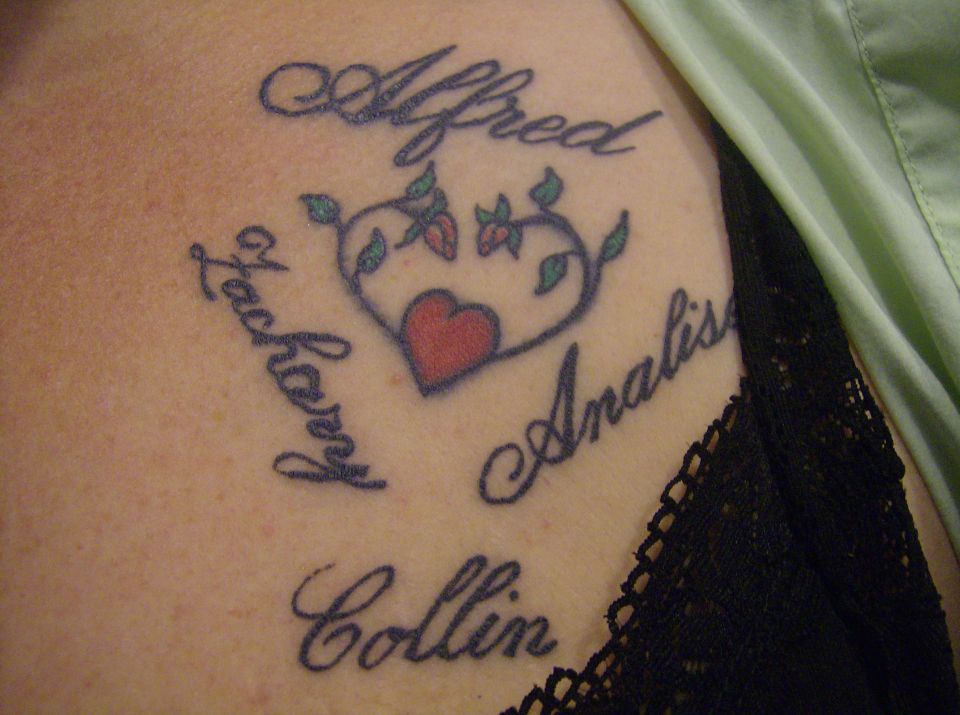 Tattoo with names Alfred, Zachary, Analis, and Collin around a heart.