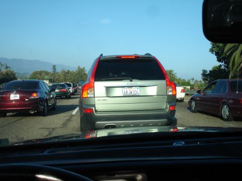1990 Ford Taurus - A silver Volvo XC90 is seen from behind in heavy traffic on a sunny day.