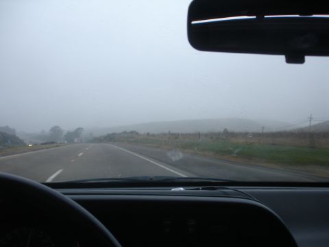 1990 Ford Taurus - Driving on a foggy highway with limited visibility and rain on the windshield.