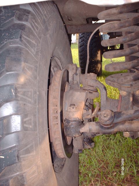 1982 Ford F-100 - Close-up side view of the front wheel, brake rotor, and suspension components of a vehicle, likely a truck, with a date stamp of 07/26/2008…