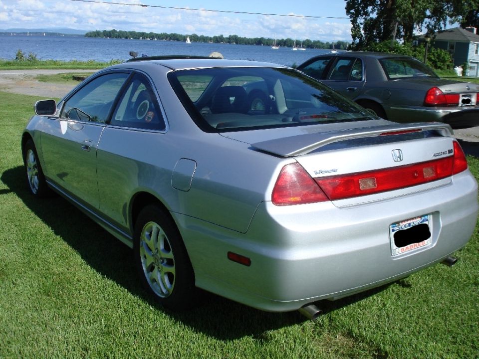 Silver 2002 Honda Accord coupe, rear passenger side view, parked on grass by water