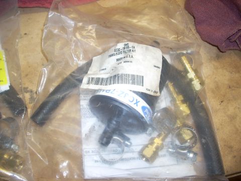 1992 Ford Bronco - A plastic-wrapped transmission fluid filter kit is shown, including hoses and brass fittings. The label reads "ONE XC3Z-78155-CA TRANS FLUI…