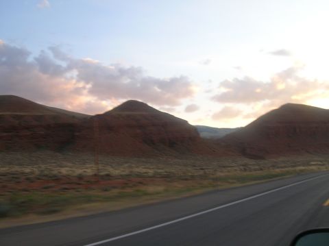 1996 Ford Bronco - A scenic drive through a landscape of rolling hills and a vast sky at dusk.