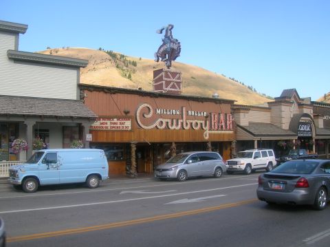 1996 Ford Bronco - A street scene in front of the Million Dollar Cowboy Bar shows several vehicles parked along the road.