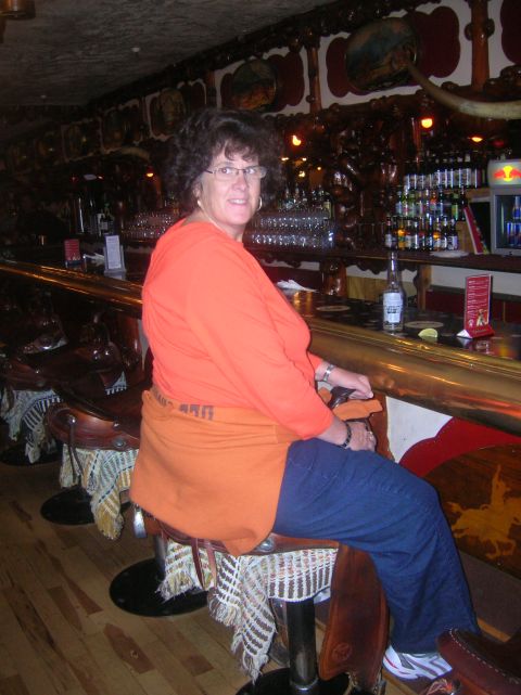 1996 Ford Bronco - A woman sits at a bar in a room decorated with western-themed items.