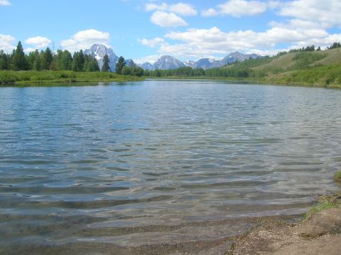 1996 Ford Bronco - A wide shot of a lake with mountains in the distance on a clear day.