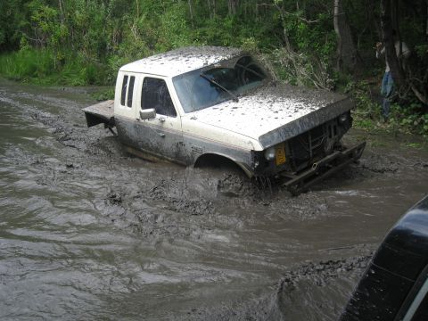 1990 Ford F-250 - This 1990 Ford F-250 is deeply stuck in thick mud during an off-road excursion.