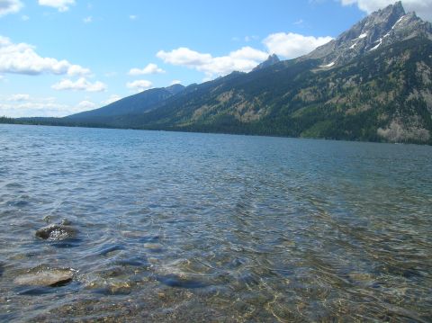 1996 Ford Bronco - A scenic view of a lake with mountains in the background on a clear day.