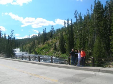 1996 Ford Bronco - A group enjoys a scenic view of a river and dense forest from a bridge on a sunny day.