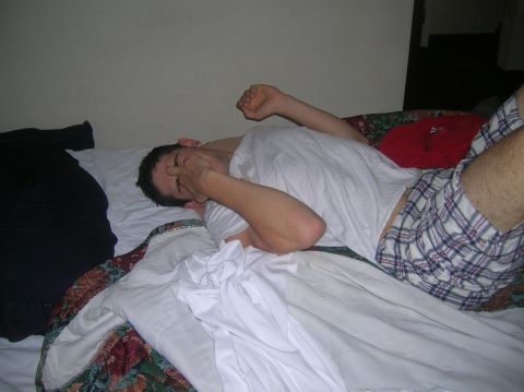 1996 Ford Bronco - A man lies on a bed, appearing to be asleep or exhausted.