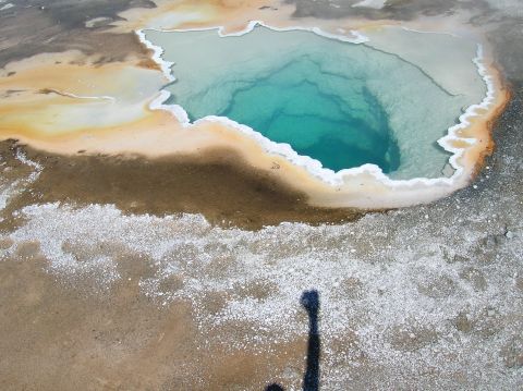 1996 Ford Bronco - A geothermal hot spring displays vibrant blue water surrounded by colorful mineral deposits.
