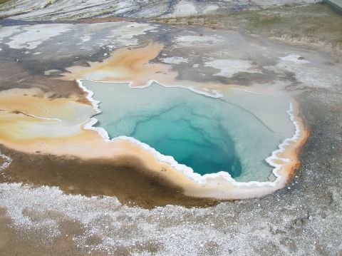 1996 Ford Bronco - A vibrant turquoise pool surrounded by mineral-rich earth, the natural beauty of a geothermal area.