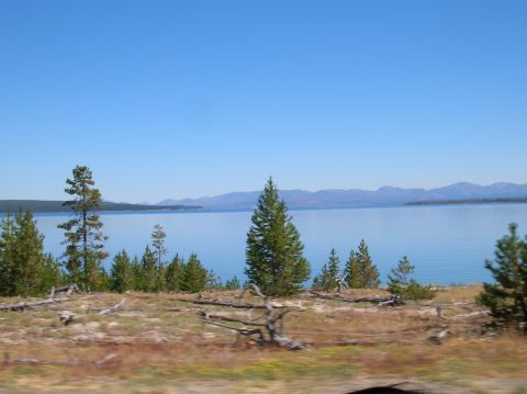 1996 Ford Bronco - A wide view of a calm lake surrounded by hills and trees on a sunny day.