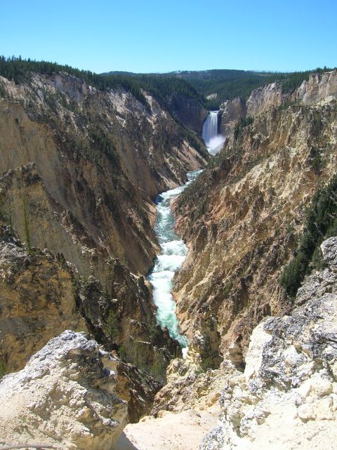 1996 Ford Bronco - A wide shot of the Grand Canyon of the Yellowstone River with a waterfall in the distance.