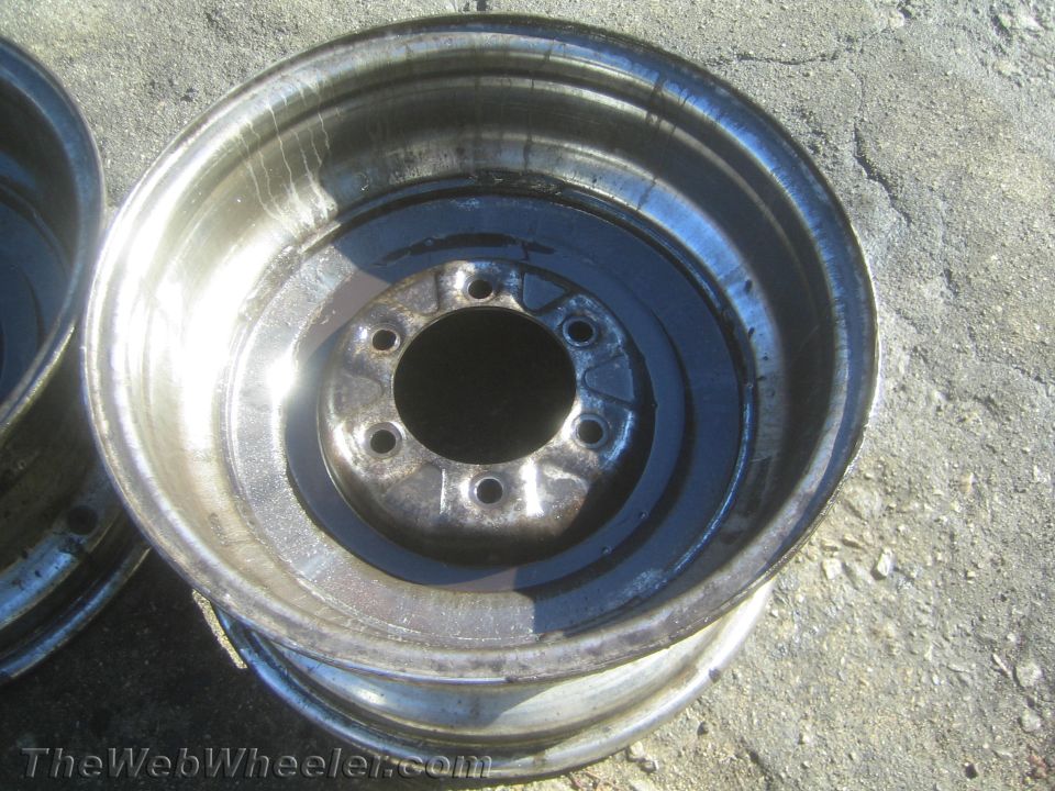 Close-up of a steel wheel rim center on pavement