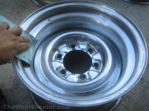 1987 Suzuki Samurai - Photograph of a polished steel wheel rim, not a technical document.