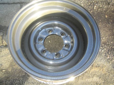 1987 Suzuki Samurai - Photograph of a primer-gray steel wheel rim, not a technical document.