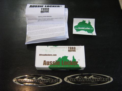 1990 Ford Bronco - Installation manual and box for an Aussie Locker differential, along with related stickers.