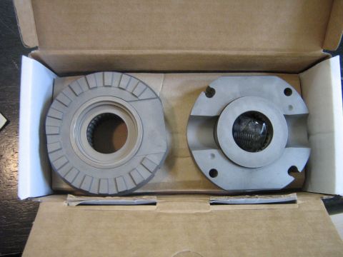 1990 Ford Bronco - Two metal components, likely for a vehicle's drivetrain, are presented in a cardboard box.