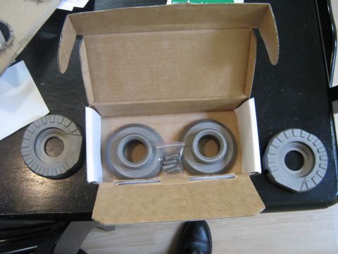 1990 Ford Bronco - Automotive parts are laid out on a table, some inside a cardboard box.