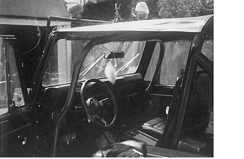 1991 Ford Bronco - Interior view of a vintage SUV, likely a 1991 Ford Bronco, showing the dashboard, steering wheel, seats, and a soft top roof.