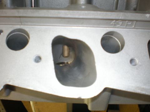 2007 Ford Mustang - Photograph of a cylinder head intake port with cast marking 49 PI, not a technical document.
