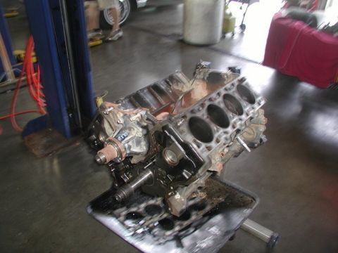 2007 Ford Mustang - Photograph of a disassembled V8 engine short block sitting in an automotive shop, not a technical document.