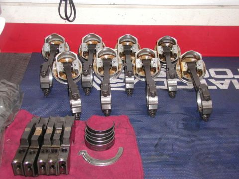 2007 Ford Mustang - Photograph of pistons, connecting rods, main caps and bearing shells arranged on a towel, a parts photo not a diagram.