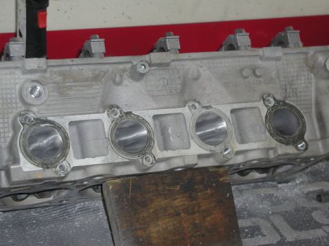2007 Ford Mustang - Photograph of a cylinder head showing intake ports and gasket surfaces, a physical part not a technical document.