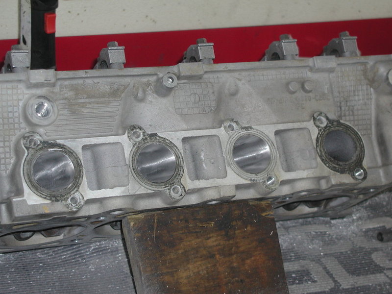 Photo of a cylinder head intake port face on a bench
