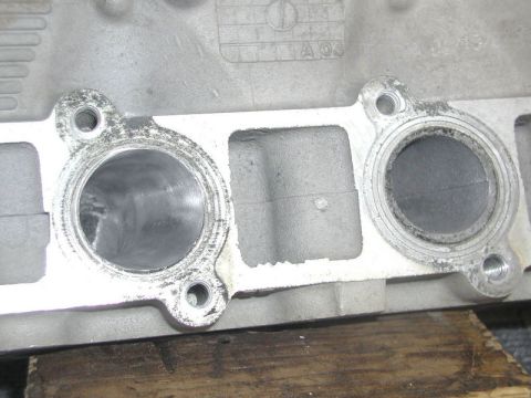 2007 Ford Mustang - Close-up photograph of cylinder head intake ports with casting marks, a physical part not a technical document.