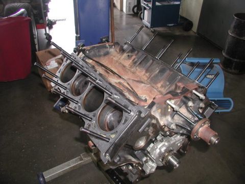 2007 Ford Mustang - Engine block assembly on a stand, showing cylinder bores and part of the oil pump mechanism.