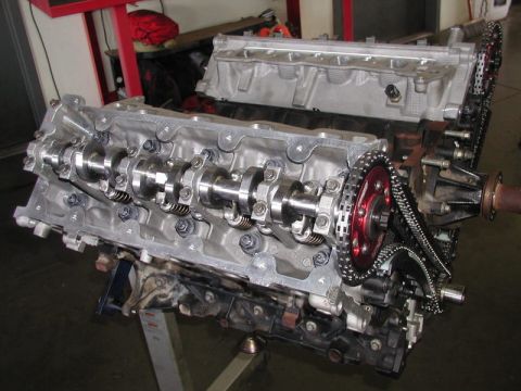 2007 Ford Mustang - Close-up view of an engine's internal components, including camshafts and a timing chain, in a workshop setting.