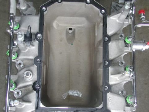 2007 Ford Mustang - This is a close-up view of an engine intake manifold, showing its internal structure and attached fuel injectors.