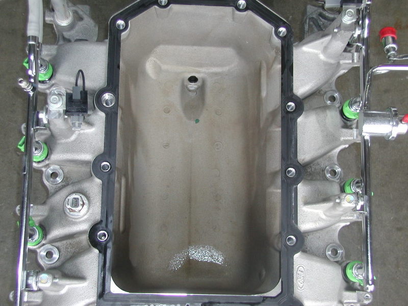 Close-up of an engine intake manifold with fuel injectors