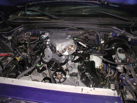 2007 Ford Mustang - The engine bay of a vehicle, a supercharger and intake manifold.