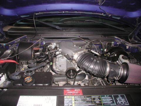 2007 Ford Mustang - Close-up view of a supercharged engine bay, showing various components and a Ford SVT label.
