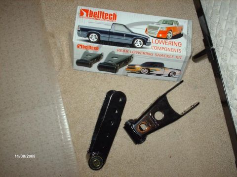 1990 Ford F-150 - Belitech lowering components box and parts are laid out on a carpeted surface.