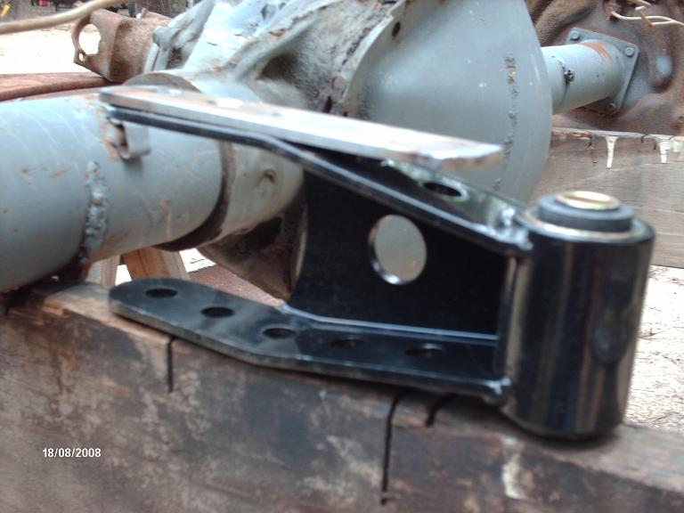 Black suspension bracket attached to a gray axle