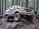 1989 Ford Bronco - This 1989 Ford Bronco is shown off-roading on a wet, wooded path.