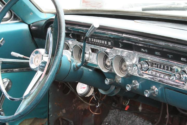 Teal interior dashboard with chrome accents and a vintage radio